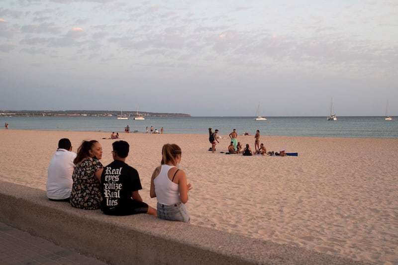 12. A family enjoys the sunset in Platja d'Or in Palma de Mallorca. AFP