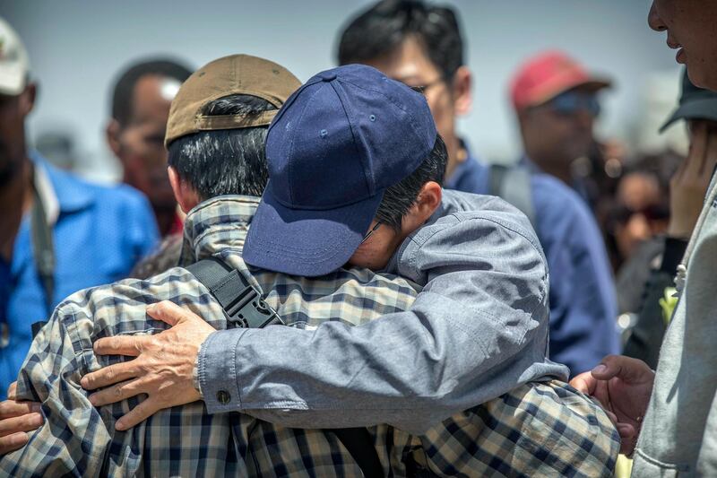 Family members hug each other at the scene where the Ethiopian Airlines Boeing 737 Max 8 crashed shortly after takeoff on Sunday. AP