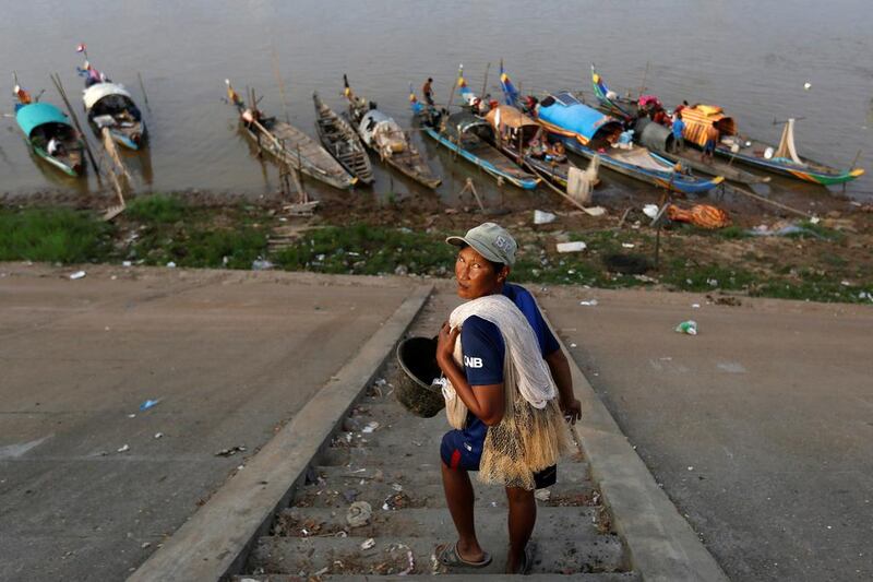 A man carries his fishing net on Tonle Basac riverbank in Phnom Penh, Cambodia on January 20, 2017. Samarang Pring / Reuters