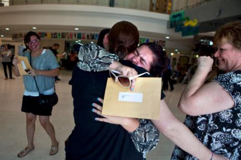 British School al Khubairat student Parisa Nigani, 18, hugs a friend as she reacts to her A-level test results on Thursday, August 18, 2011, at the school in Abu Dhabi. Thousands of students around the Commonwealth nations received their results today. In Abu Dhabi, some came in person but others called in for their results as they were still traveling on their summer vacations. (Silvia Razgova/The National)

