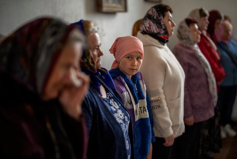 Ukrainians attend a solemn religious service to commemorate the fallen in the Russian occupation in Zdvyzhivka, on the outskirts of Kyiv. AP