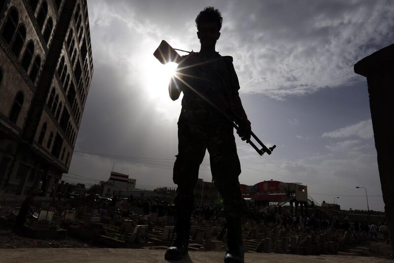epa06797587 A Yemeni soldier stands guard as people bury the bodies of Houthi militia members allegedly killed during recent fighting at Yemenâ€™s western coast areas, during the funeral procession at a cemetery in Sana'a, Yemen, 09 June 2018. The Saudi-led coalition launched more than three years ago a military campaign against the Houthi rebels and allied positions in Yemen, sparking a full-blown armed conflict.  EPA/YAHYA ARHAB