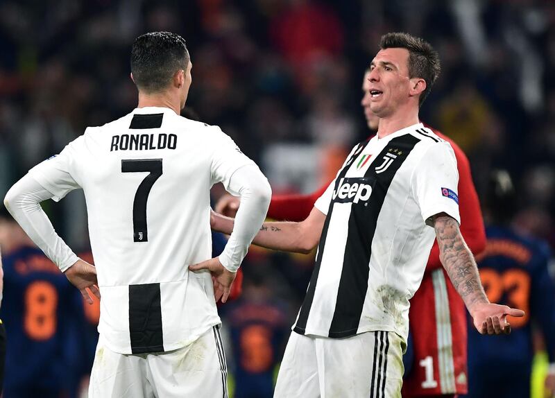 Juventus forward Mario Mandzukic, right, and Cristiano Ronaldo celebrate at the full-time whistle. Mandzukic's goal was enough to win the match 1-0 and see Juve progress to the last 16. AFP