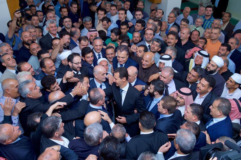 Syria's President Bashar al-Assad greets his supporters during Eid al-Adha prayers at a mosque in the town of Qara, north of Damascus, in this handout picture provided by SANA on September 1, 2017, Syria. SANA/Handout via REUTERS ATTENTION EDITORS - THIS IMAGE WAS PROVIDED BY A THIRD PARTY. REUTERS IS UNABLE TO INDEPENDENTLY VERIFY THIS IMAGE.     TPX IMAGES OF THE DAY