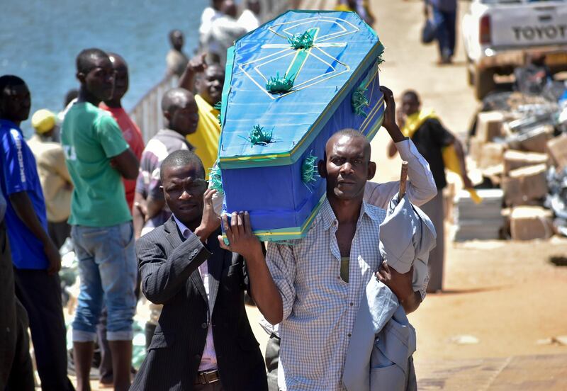 Men carry a coffin for one of the victims of the MV Nyerere passenger ferry on Ukara Island, Tanzania Saturday, Sept. 22, 2018. The death toll soared past 200 on Saturday while officials said a survivor was found inside the capsized ferry and search efforts were ending to focus on identifying bodies, two days after the Lake Victoria disaster. (AP Photo)
