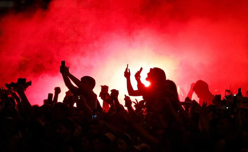 Supporters light flares in Cibeles Square after the Real Madrid team bus returns from Santander after clinching their first Primera Liga title in five years. Paul Hanna / Reuters