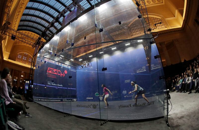 Raneem El Welily, left, of Egypt, plays against Nour El Tayeb, also of Egypt during a Professional Squash Association World Championships match at a glass squash court in Union Station's Great Hall. AP