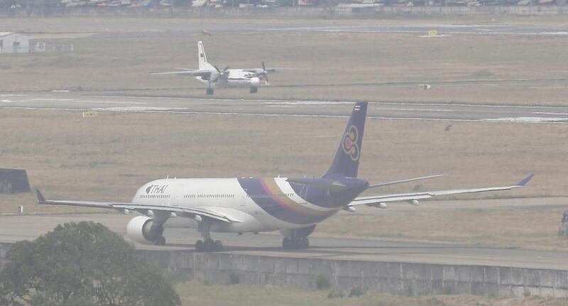 A military aircraft lands in hazy weather at the Tan Son Nhat airport in Ho Chi Minh City after its search and rescue mission. Reuters