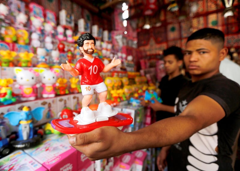 A man displays a toy figure bearing the image of Liverpool's Mohamed Salah are seen at a market, before the beginning of the holy fasting month of Ramadan in Cairo, Egypt. Amr Abdallah Dalsh / Reuters