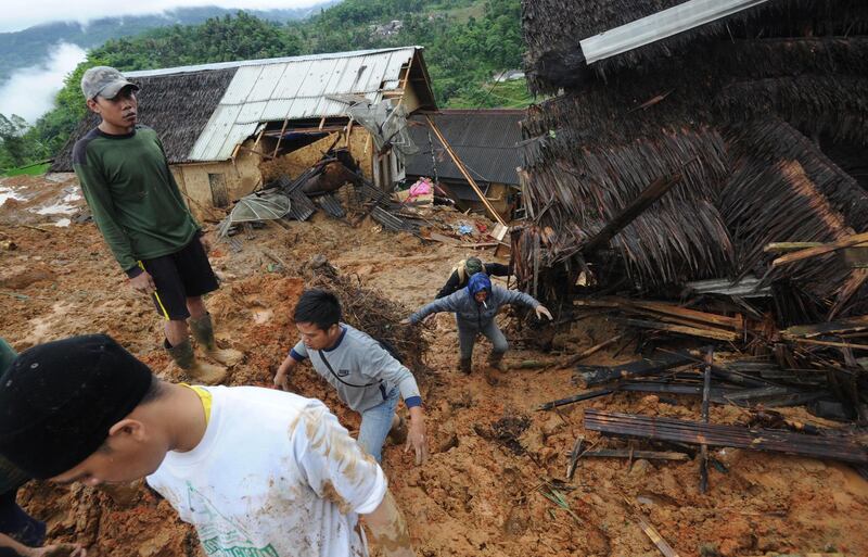 Indonesian villigers and rescuers search for landslide victims at Sirnaresmi village in Sukabumi, Indonesia.  EPA