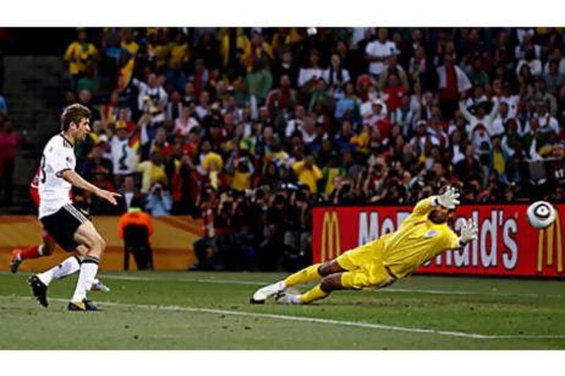 Thomas Mueller, left, scores  Germany's fourth past the hapless David James to clinch their passage to the quarter-finals of the World Cup.