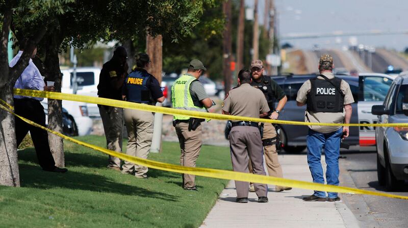 Authorities cordon off a part of the sidewalk in the 5100 block of E. 42nd Street in Odessa, Texas. Several people were dead after a gunman who hijacked a postal service vehicle in West Texas shot more than 20 people, authorities said Saturday. The gunman was killed and a few law enforcement officers were among the injured. AP