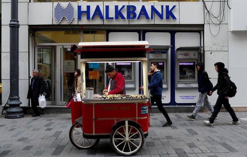 FILE PHOTO: A street vendor sells roasted chestnuts in front of a branch of Halkbank in central Istanbul, Turkey, January 10, 2018. REUTERS/Murad Sezer/File Photo