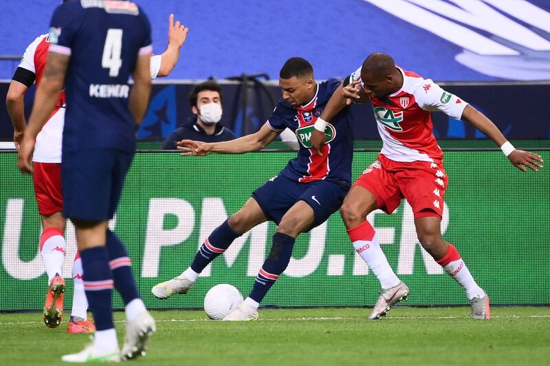 Paris Saint-Germain forward Kylian Mbappe fights for the ball with Monaco's Djibril Sidibe.