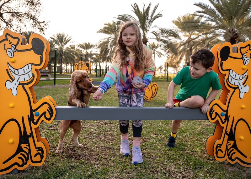 Ethan Mulholland, 6, and Beth, 8, play with their dog Marley at the new park in Al Khubeirah. All photos: Victor Besa / The National