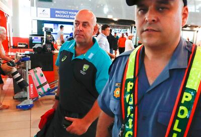 epa06631766 Australian cricket coach Darren Lehmann (L) departs from Cape Town International airport, South Africa, 27 March 2018. Australia skipper Steve Smith has been suspended by the International Cricket Council (ICC) for his part in a ball tampering scandal during the third test against South Africa. Smith admitted some senior players were aware of the ball tampering attempt. Smith and David Warner stepped down as captain and vice-captain of the Australian team in consequence to the ball meddling scandal.  EPA/NIC BOTHMA