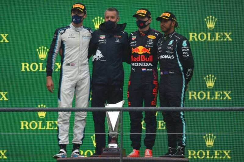 Race winner Max Verstappen, second left, George Russell, left, who finished second, and third placed Lewis Hamilton, right. Getty