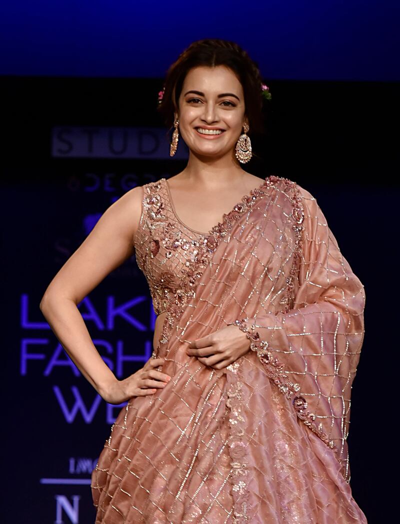 Actress Dia Mirza flashes her famous smile in a Moksha & Hiral ensemble. AFP