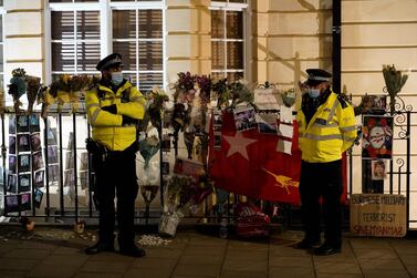 Police officers stand on duty outside the Myanmar Embassy in London on April 7, 2012. AFP