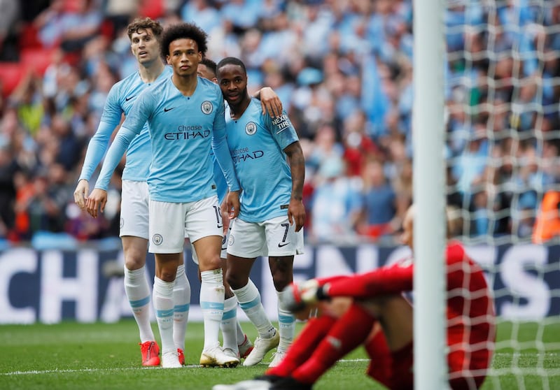 Manchester City's Raheem Sterling celebrates with Leroy Sane and John Stones after scoring their sixth goal to complete his hat-trick. Reuters