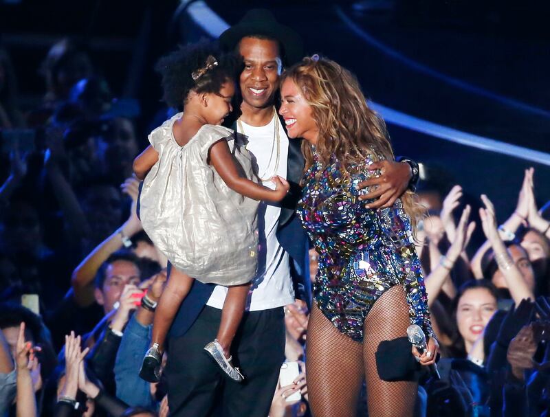 Beyonce smiles with Jay-Z and daughter Blue Ivy after accepting the Video Vanguard Award on stage during the 2014 MTV Video Music Awards in Inglewood, California August 24, 2014. Reuters