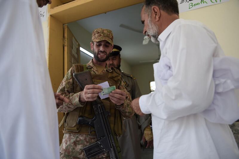 A Pakistani soldier checks a voters information in Islamabad. AFP