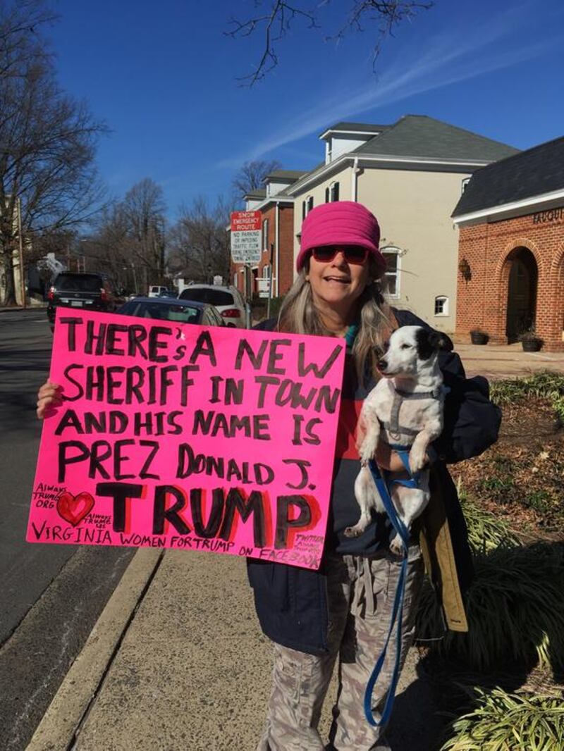 Kelly Anne Finn and her dog Jack in Warrenton, Virginia, with a sign she made in support of US president Donald Trump. Thomas Seibert for The National