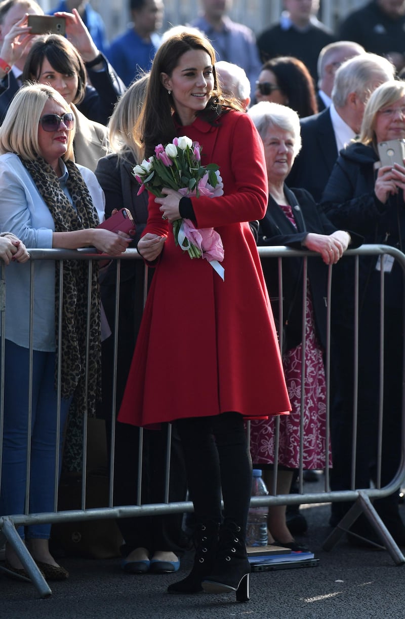 Arriving in Northern Ireland for an unannounced visit with Prince William, the Duchess of Cambridge wears a red Carolina Herrera coat, black jeans and LK Bennett Marissa booties.  EPA