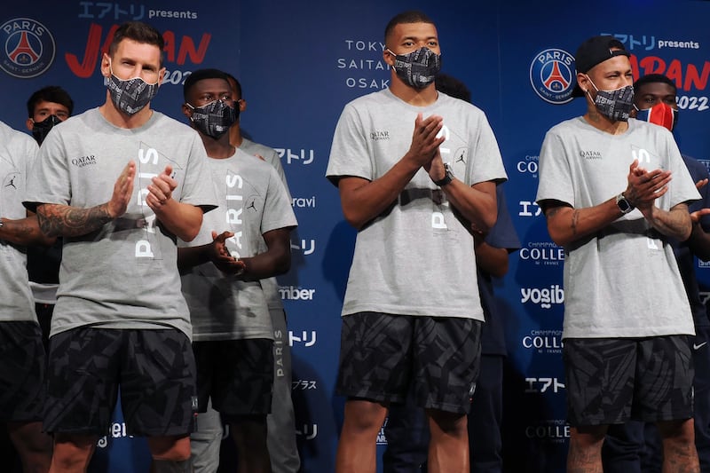 Lionel Messi, Kylian Mbappe and Neymar applaud during a reception party at a Tokyo hotel. AFP