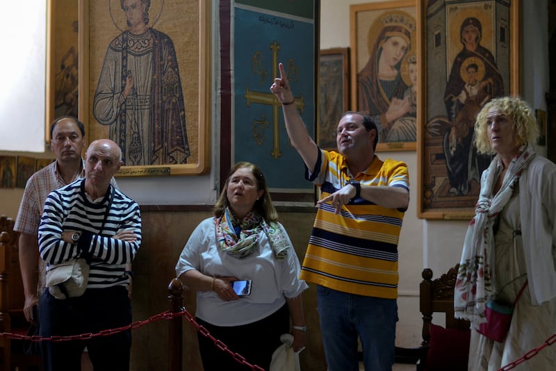 Tourists visit St George's Greek Orthodox Church, in Madaba, Jordan.