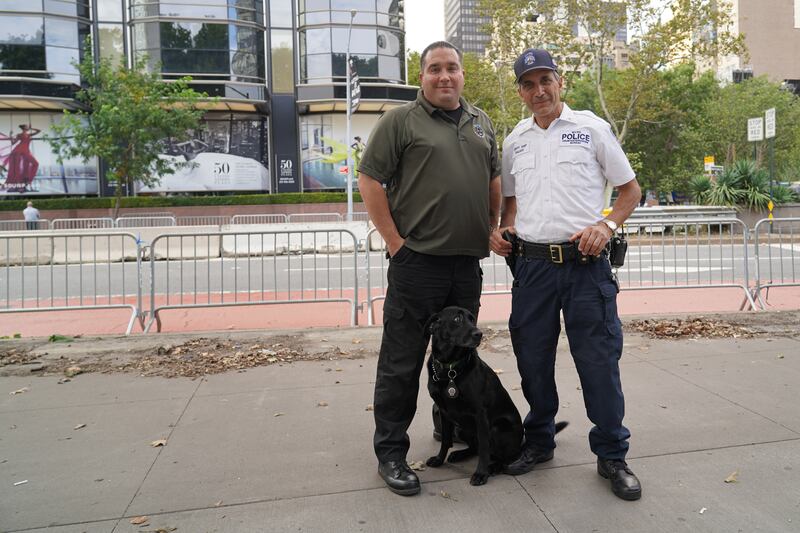 NYPD Deputy Chief of Counterterrorism Joseph Gallucci poses with Bobby, the bomb-sniffing dog, and his handler outside UN headquarters. Willy Lowry / The National