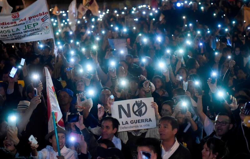 People protest against a reform proposed by the government for the Special Jurisdiction for Peace with a sign reading "No to war" in Bogota, Colombia. AFP