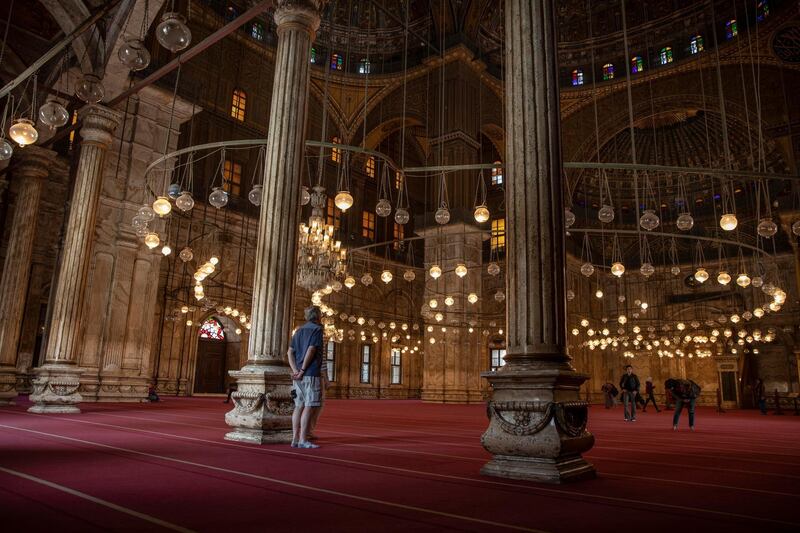 An American tourist looks at the great Mosque of Muhammad Ali Pasha at the Citadel complex, in Cairo, Egypt, on March 18, 2020. AP Photo