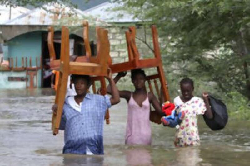 People salvage items during flooding from Tropical Storm Hanna, in L'Artibonite, northern Haiti, Tuesday, Sept. 2, 2008. The storm has spawned flooding in Haiti that left 10 people dead in Gonaives, along Haiti's western coast, according to the country's civil protection department. (AP Photo/Ariana Cubillos) *** Local Caption ***  XAC101_Haiti_Tropical_Weather.jpg