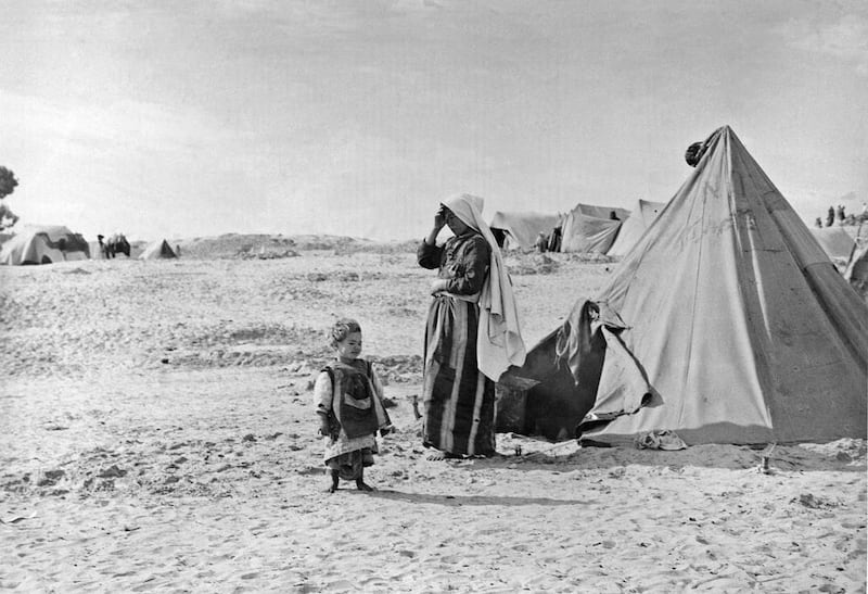 Palestinian refugees stand outside their tent in Khan Younis, Gaza Strip in 1948. AP Photo/UNRWA Photo Archives