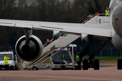 British nationals evacuated from Wuhan in China amid the novel coronavirus outbreak disembark a chartered passenger jet at the Royal Air Force station RAF Brize Norton in Carterton, west of London, on January 31, 2020.  A charter plane carrying evacuees from the Chinese city at the centre of the deadly novel coronavirus outbreak arrived at Royal Air Force base Brize Norton in Britain on January 31. The flight touched down shortly after 1:30 pm (1330 GMT), with 83 British citizens and 27 others on board.  / AFP / Adrian DENNIS
