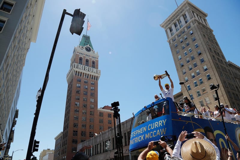 Golden State Warriors guard Stephen Curry holds up the Larry O'Brien NBA Championship Trophy. John G. Mabanglo / EPA