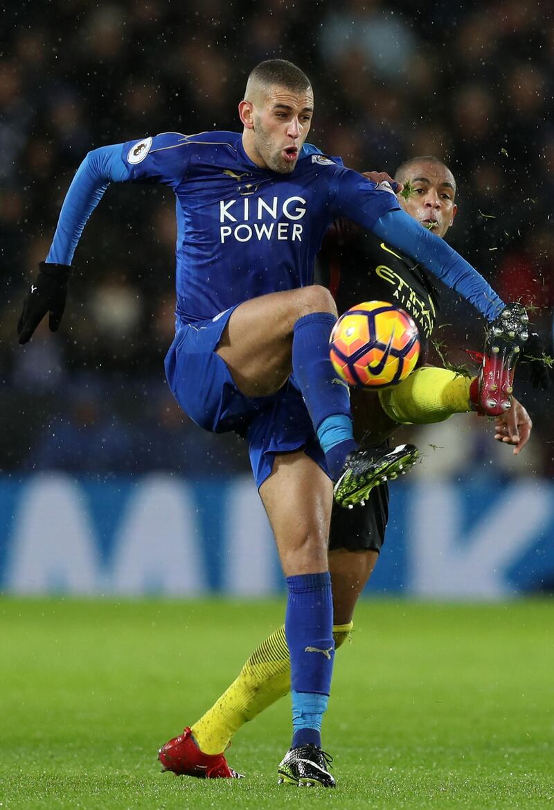 LEICESTER, ENGLAND - DECEMBER 10: Islam Slimani of Leicester City (L) and Fernando of Manchester City (R) battle for possession during the Premier League match between Leicester City and Manchester City at the King Power Stadium on December 10, 2016 in Leicester, England.  (Photo by Christopher Lee/Getty Images)
