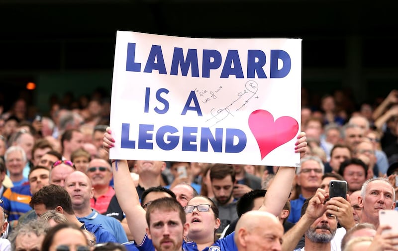 A Chelsea fan holds a banner up for Lampard. PA