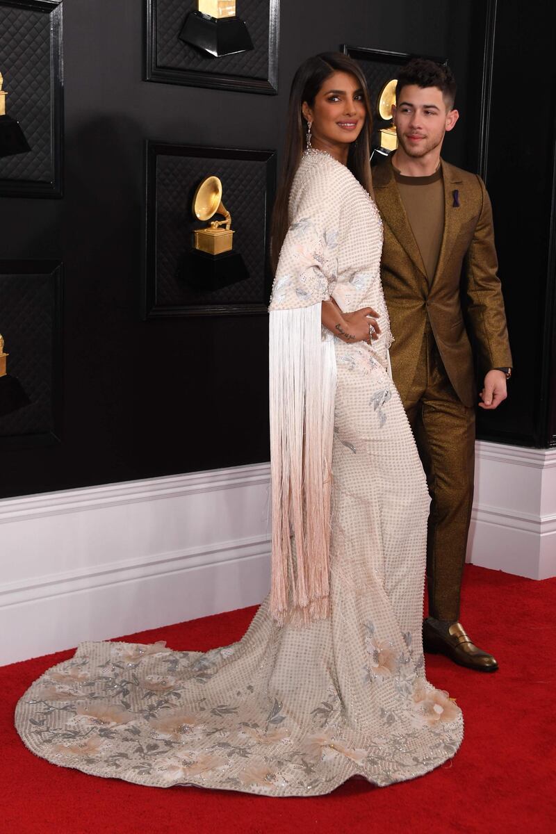 Actress Priyanka Chopra wears Ralph & Russo, joined by singer-songwriter husband Nick Jonas at the 62nd Annual Grammy Awards on January 26, 2020, in Los Angeles.  AFP