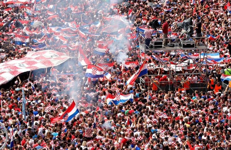 Supporters cheer while waiting for the arrival of the Croatian national football team in central Zagreb. Antonio Bat / EPA