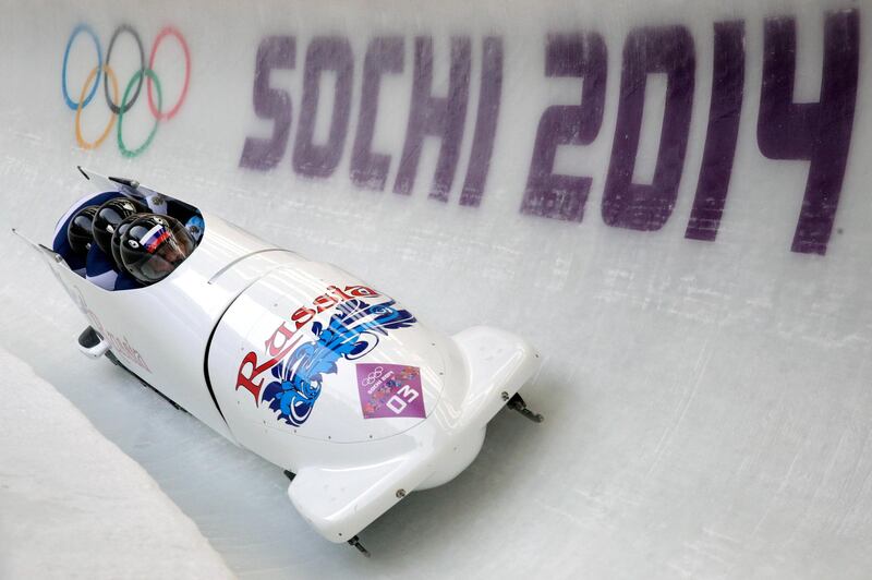 SOCHI, RUSSIA - FEBRUARY 23:  Pilot Alexander Zubkov, Alexey Negodaylo, Dmitry Trunenkov and Alexey Voevoda of Russia team 1 make a run during the Men's Four-Man Bobsleigh on Day 16 of the Sochi 2014 Winter Olympics at Sliding Center Sanki on February 23, 2014 in Sochi, Russia.  (Photo by Adam Pretty/Getty Images)