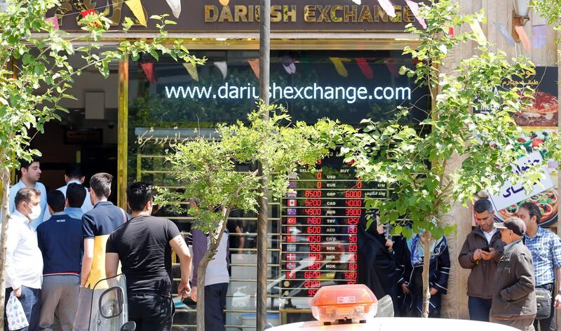 epa06660324 Iranians check the currency rate around an exchanges shop in Tehran, Iran, 10 April 2018. Media reported that President Hassan Rouhani and his cabinet have been criticized for the slide of the currency, as the US dollar is risen by 40 percent against the rial, which comes as US President Donald Trump threatens to pull out of a nuclear deal and re-impose potentially crippling sanctions. Iran moved to enforce a single exchange rate to the dollar, banning all unregulated trading after the country's currency, the rial felt in low against US dollar.  EPA/ABEDIN TAHERKENAREH