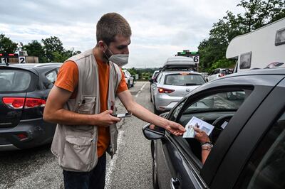 An employee at Safari de Peaugres checks the Covid-19 health pass of a visitor to the park in central France. AFP