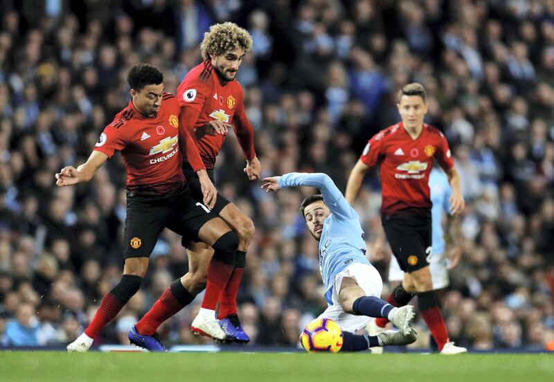Soccer Football - Premier League - Manchester City v Manchester United - Etihad Stadium, Manchester, Britain - November 11, 2018  Manchester United's Jesse Lingard and Marouane Fellaini in action with Manchester City's Bernardo Silva   REUTERS/Darren Staples  EDITORIAL USE ONLY. No use with unauthorized audio, video, data, fixture lists, club/league logos or "live" services. Online in-match use limited to 75 images, no video emulation. No use in betting, games or single club/league/player publications.  Please contact your account representative for further details.