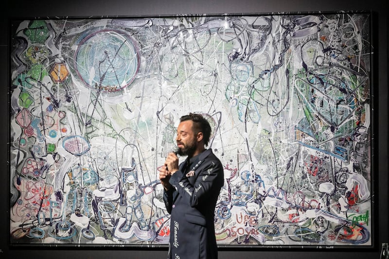 Artista Sacha Jafri talks about his art before finishing the piece by placing the last hand prints on one of his art works during the auction. Art on auction at the 100 Million Meals charity auction at the Mandarin Oriental Jumeirah in Dubai on April 24 th, 2021. 
Antonie Robertson / The National.
Reporter: Rory Reynold for National
