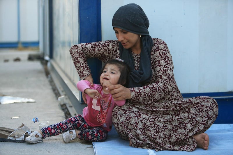 A syrian displaced woman is seen with her child, who fled violence after the Turkish offensive against Syria, at the Domiz refugee camp on the outskirts of Dohuk, Iraq. REUTERS