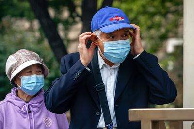 Residents with masks at a bus station in Beijing, on October 12. Beijing has tightened Covid-19 measures as the country prepares for the 20th national congress where Xi Jinping is expected to win his unprecedented third term. EPA