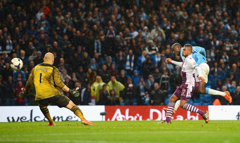 Yaya Toure of Manchester City fires a shot to score his team's fourth goal in their win over Aston Villa on Wednesday at the Etihad Stadium. Michael Regan / Getty Images / May 7, 2014