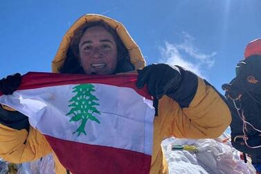 Fatima unfurls the Lebanese flag at the summit